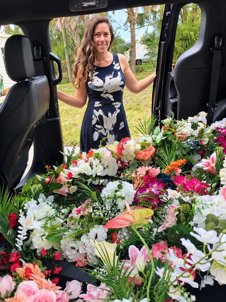 Miranda of Siesta Social Events with colorful floral arrangemants prepared for a Sarasota-area event