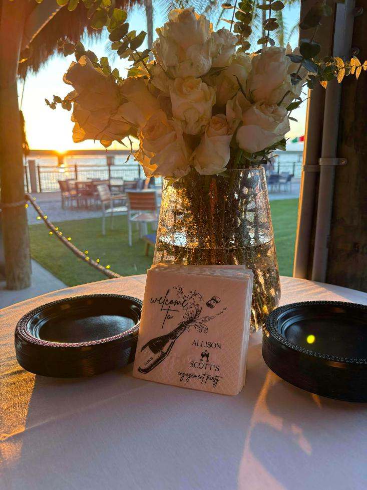 Elegant outdoor event table with soft cream floral centerpieces. Event was coordinated by Miranda Schlake owner of Siesta Social Events.