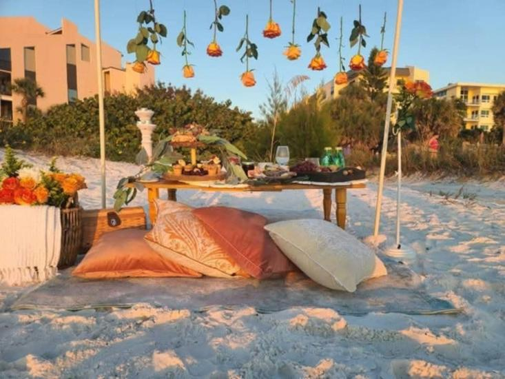 Outdoor coastal event setup with decorative lighting and seating for a private celebration