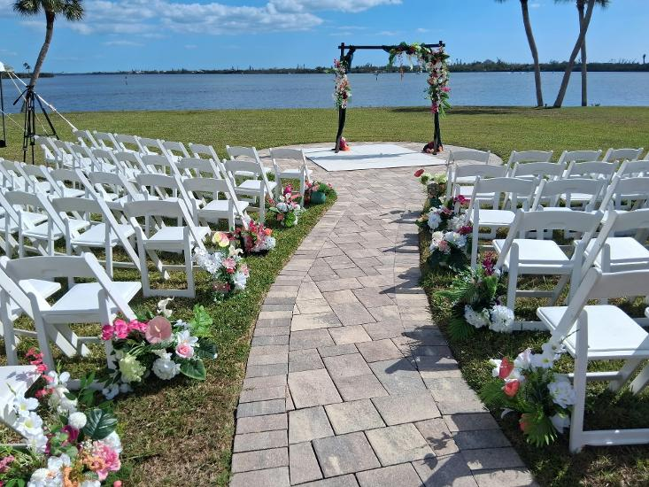 Costal walkway leading towards the beach with turquoise water and palm trees in Southwest Florida
