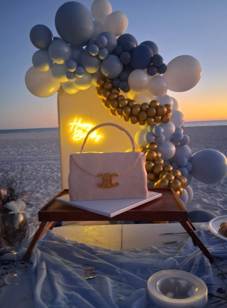 Beach celebration setup featuring a decorative balloon arrangement and coordinated event styling.