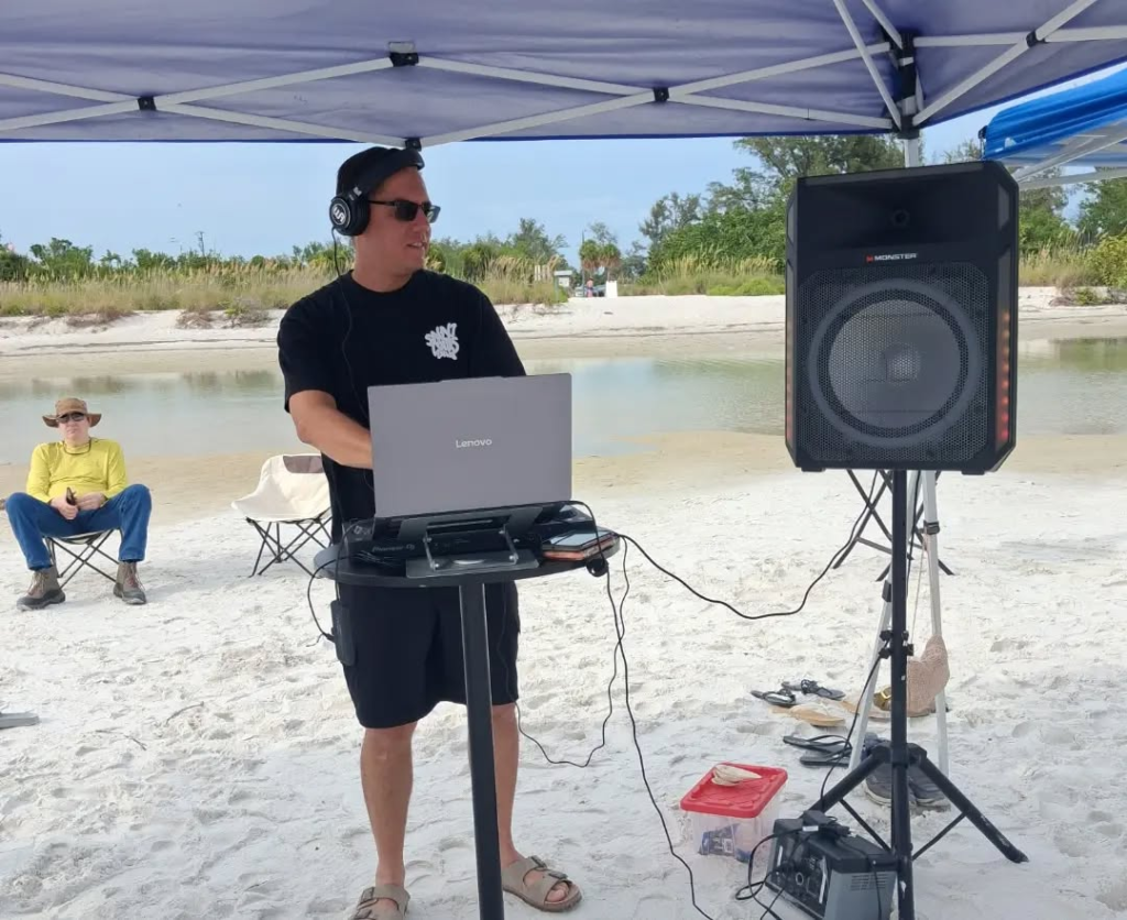 Professional DJ providing music and entertainment for an outdoor coorprate beach event in Sarasota Flroida